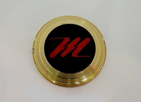 Grille medallion: 'M'