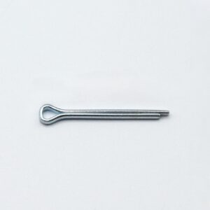 Metal cotter pin with a looped head lying on a light surface, two prongs extending to the right.